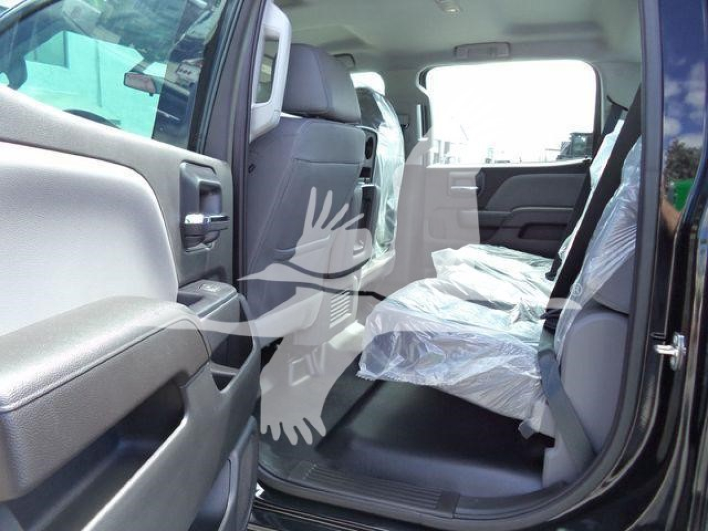 Interior of 2023 International CV truck showing front and rear seating with protective covers and open rear door.