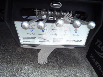 Truck control panel with four levers and diagrams, Jerr-Dan branding, showing operation instructions and labels.