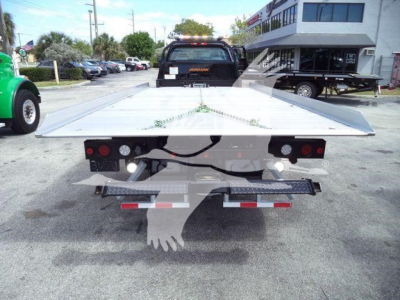 Flatbed tow truck bed from rear showing platform and taillights