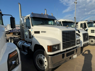 Tractor truck front view of a white 2019 Mack PI64T conventional daycab showing chrome grille, headlights, large bumper, and side mirrors.
