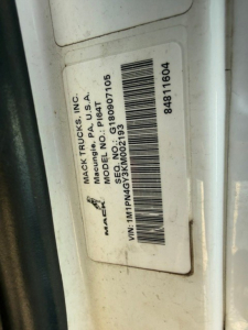 Mack PI64T vehicle label showing VIN and model information on a door jamb label.
