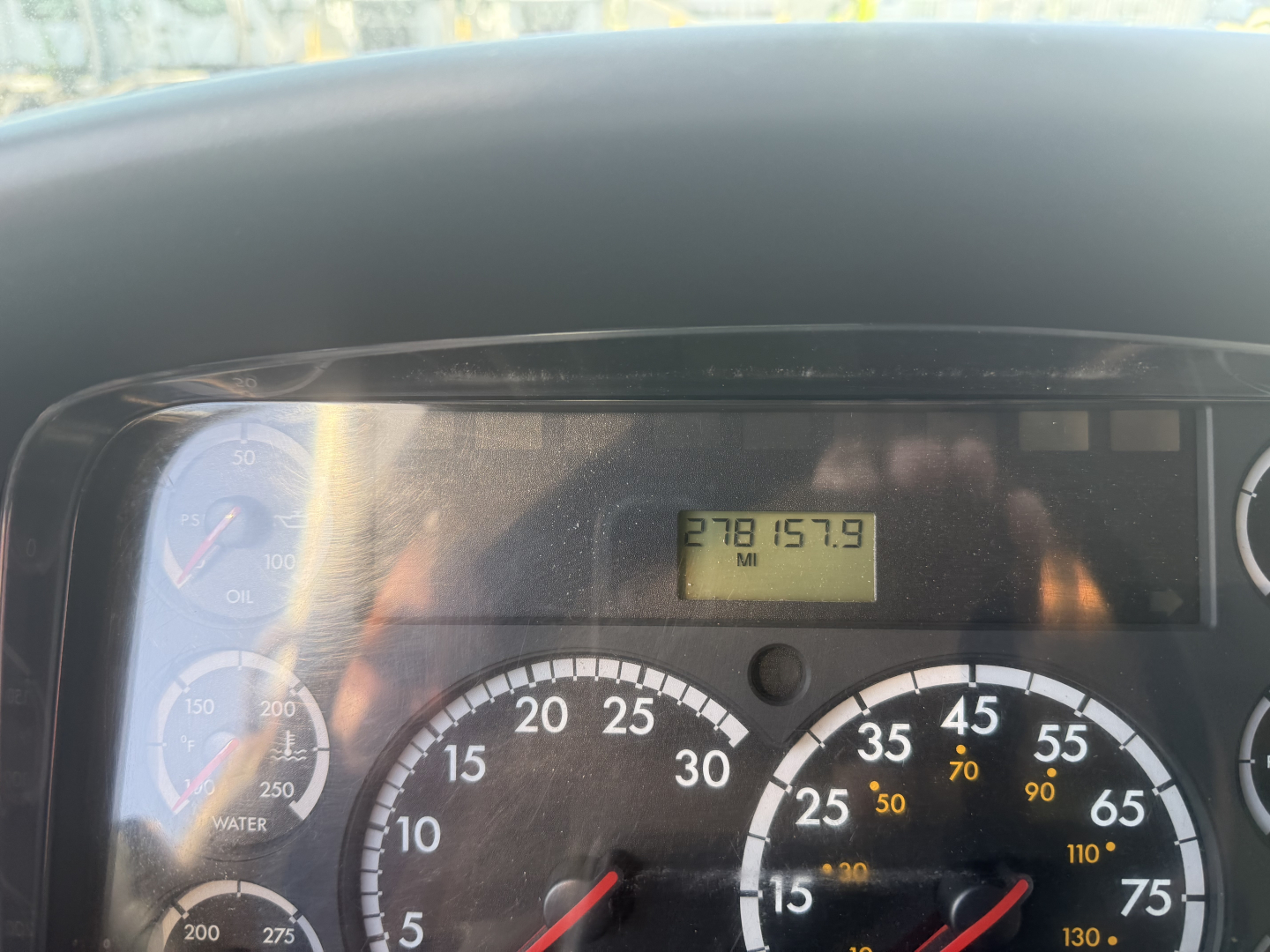 Dashboard view of a Freightliner M2106 showing gauge cluster and an odometer display reading 278157.9 miles.