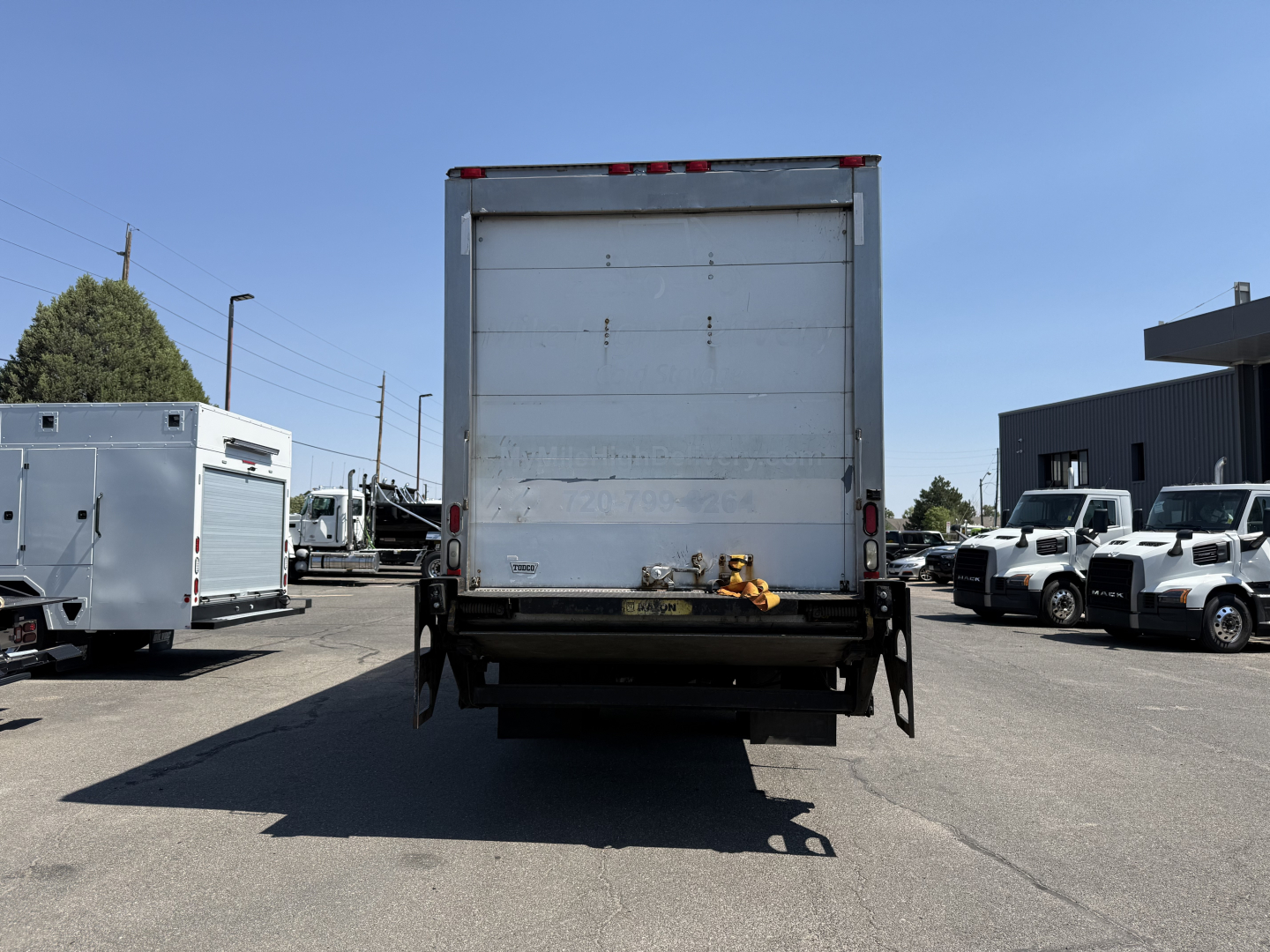 Freightliner M2106 refrigerated truck rear view showing liftgate and taillights.