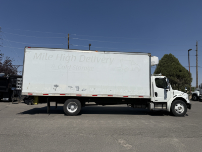 Freightliner M2106 refrigerated box truck side view showing Mile High Delivery logo on cargo area and white cab, VIN 1FVACWDT28DZ72341 visibility text not legible.