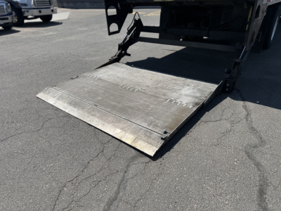 Rear loading ramp on a refrigerated 2008 Freightliner M2106 truck showing metal ramp extended.