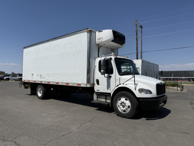 Freightliner M2106 refrigerated truck with curbside view showing cargo box and refrigeration unit