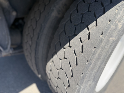 Truck chassis wheel and tire tread close-up for a 2008 Freightliner M2106 refrigeration truck.
