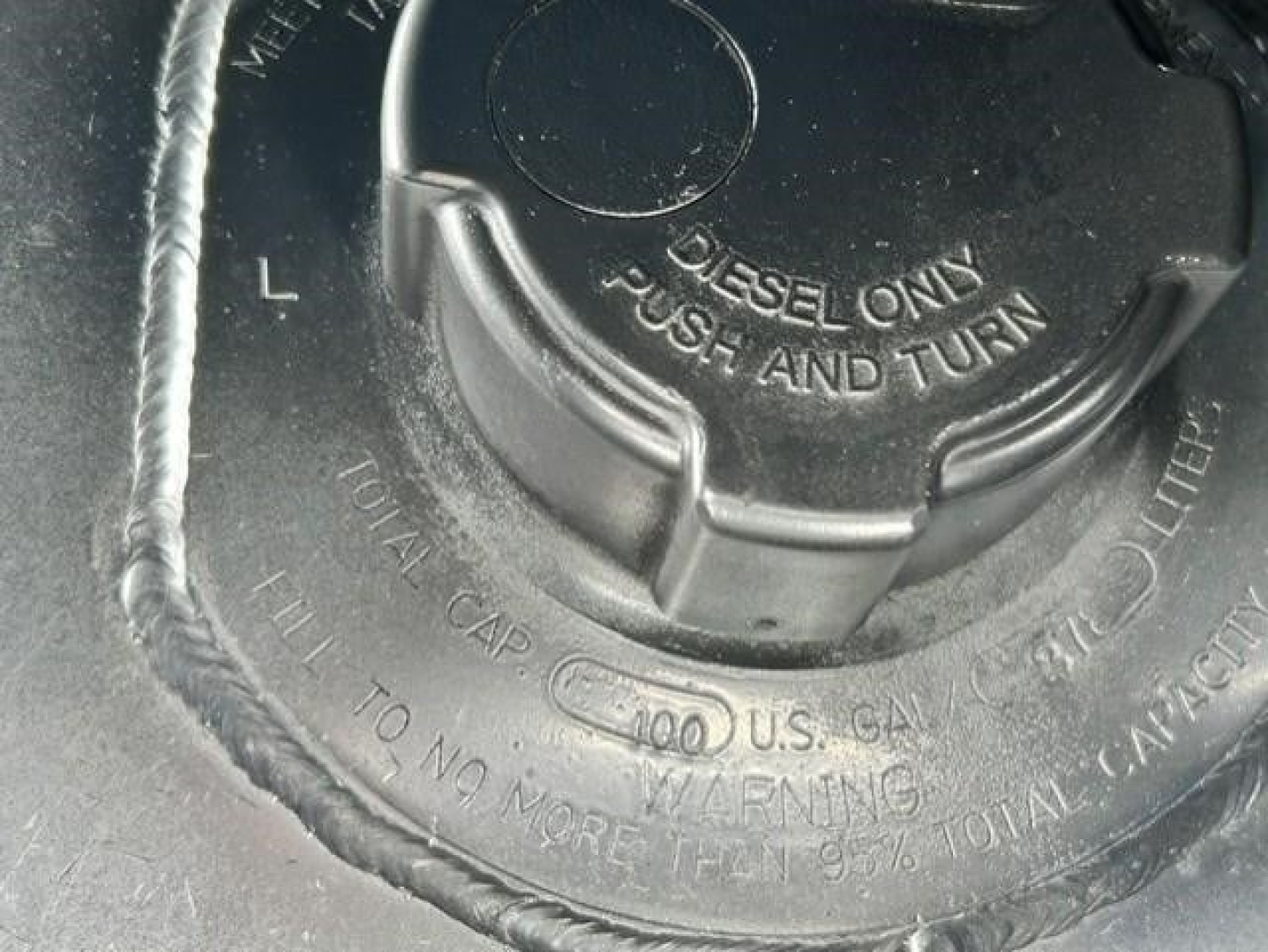 Fuel cap showing 'DIESEL ONLY' and 'PULL AND TURN' with surrounding text on a Freightliner engine bay.