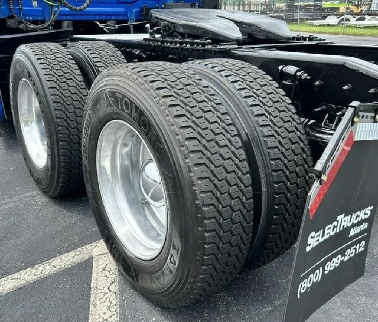Freightliner Cascadia 126 truck rear dual axle tires showing dual tires and chassis with wheel rims.