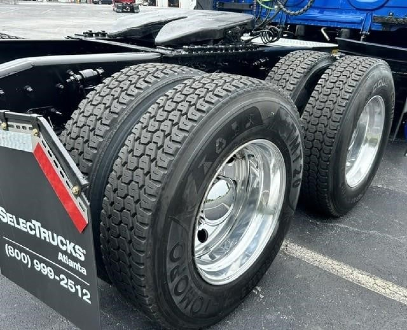 Freightliner Cascadia 126 rear wheels and chassis showing dual rear axle tires and chrome rims.