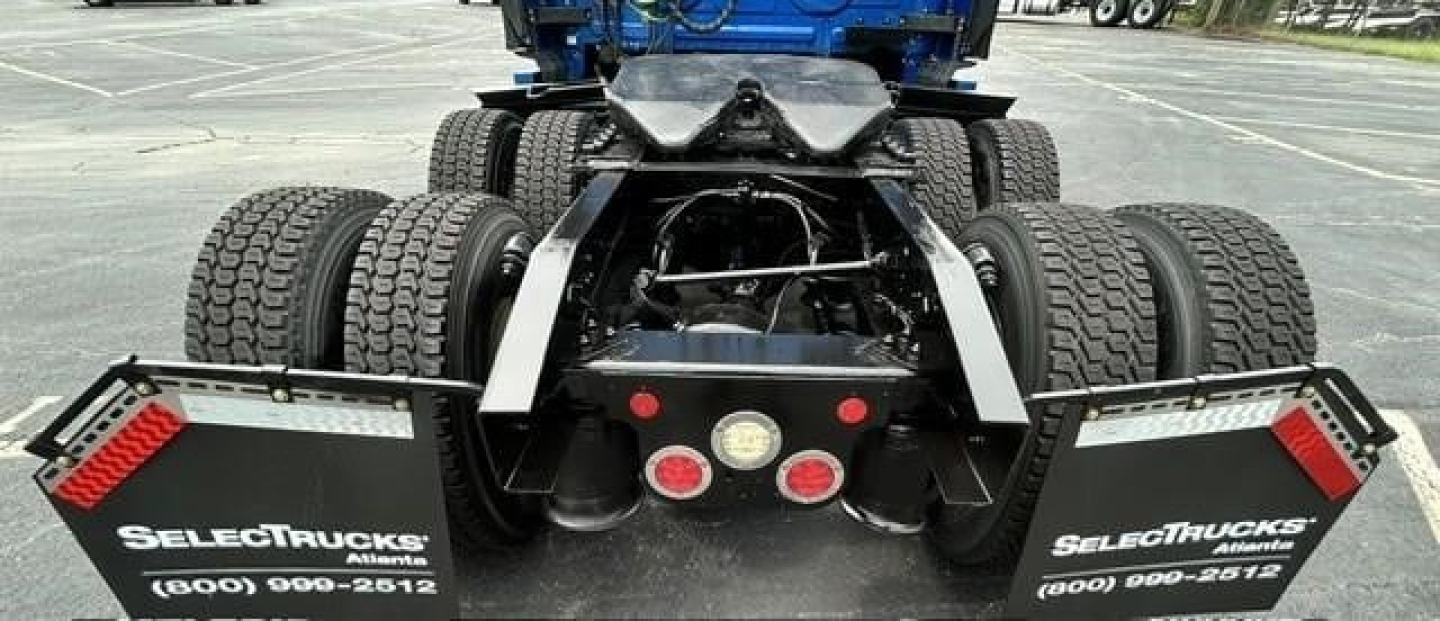 Rear of 2022 Freightliner Cascadia 126 tractor showing dual rear axles, mudflaps with SelektTrucks branding, and taillight cluster.