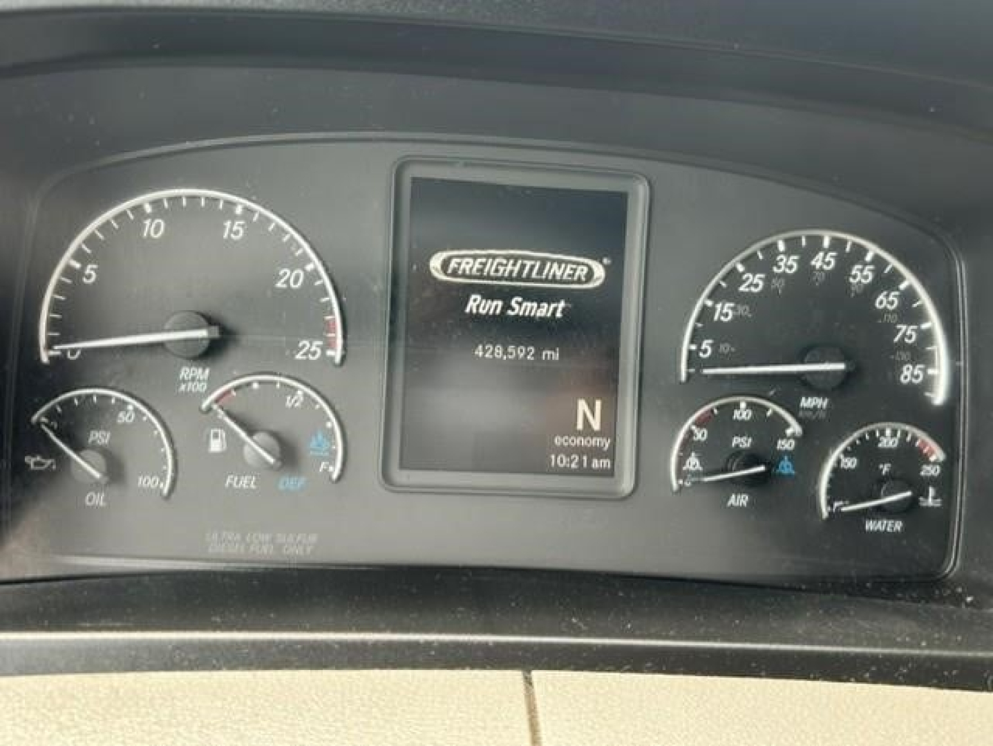 Freightliner Cascadia dash cluster with Run Smart display showing 429,592 mi and N gear; left gauge speeds/engine RPM, right gauges fuel, air, water; center screen Freightliner Run Smart.