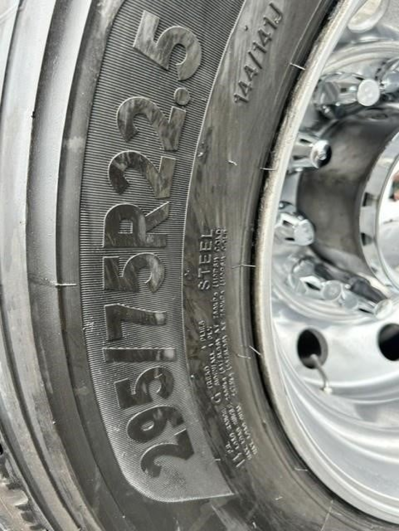 Tire sidewall with large numbers 225/70 R19.5 and steel wheel profile visible