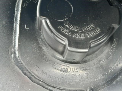 Fuel cap showing 'DIESEL ONLY' and 'PULL AND TURN' with surrounding text on a Freightliner engine bay.