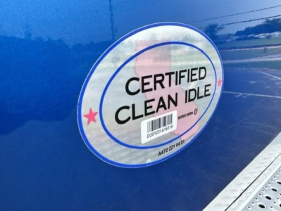 Freightliner Cascadia 126 badge reading Certified Clean Idle sticker on blue cab side.