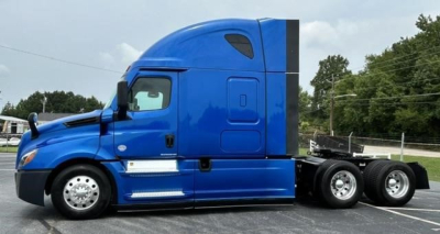 Truck side profile showing blue Freightliner Cascadia 126 sleeper tractor with 6 wheels and aerodynamic cabin, no visible text