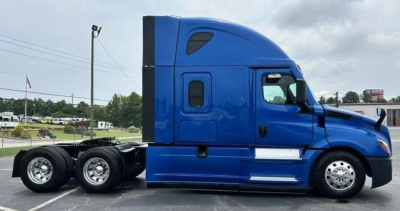 Side view of a blue 2022 Freightliner Cascadia 126 truck tractor with sleeper cab.