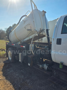 Truck side view showing a white vacuum tanker mounted on a white cab chassis. Visible text on the image includes a watermark and details like 'www.govdeals.com' on the tank area.