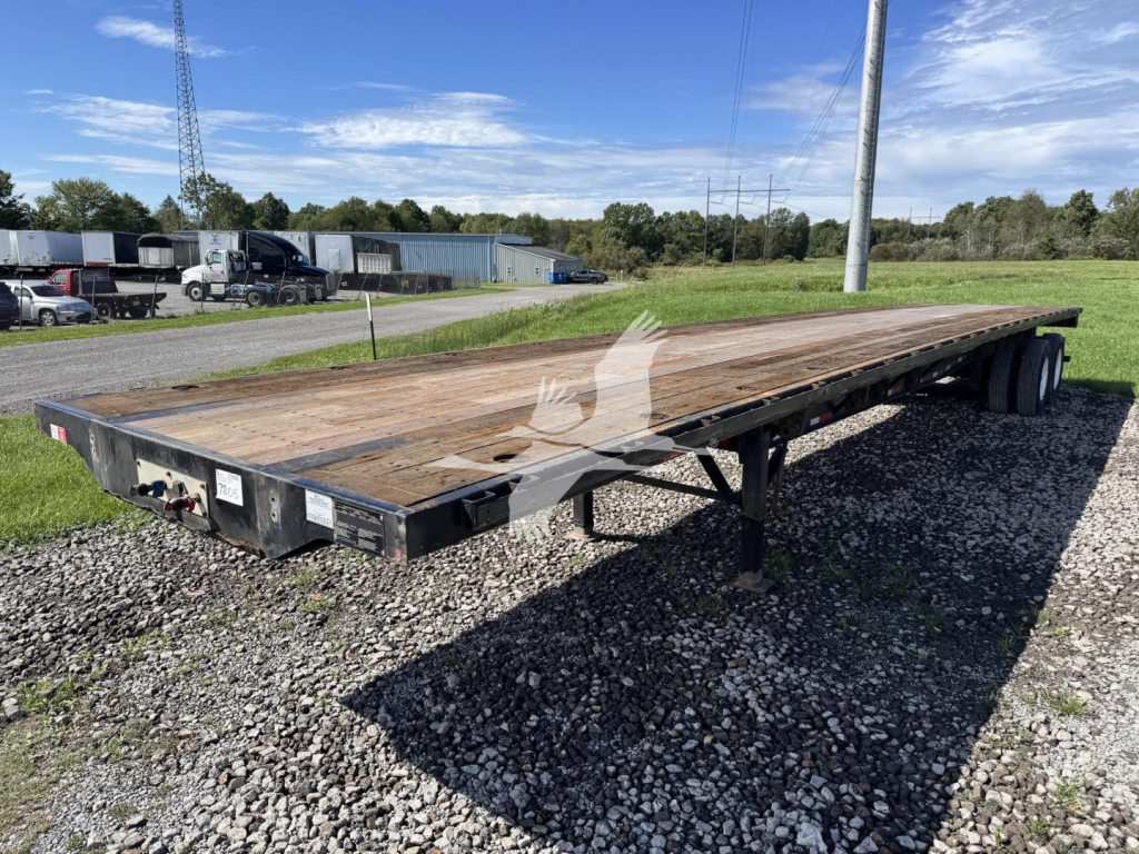 Flatbed trailer showing weathered wooden deck and dual rear wheels, 2017 Transcraft steel flatbed, VIN 1TTF482S0H3015060, stock 7805.