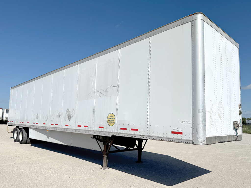 Trailer side view showing a white 2013 Wabash DuraPlate van trailer with dual rear axles and stand, stock number 553093.