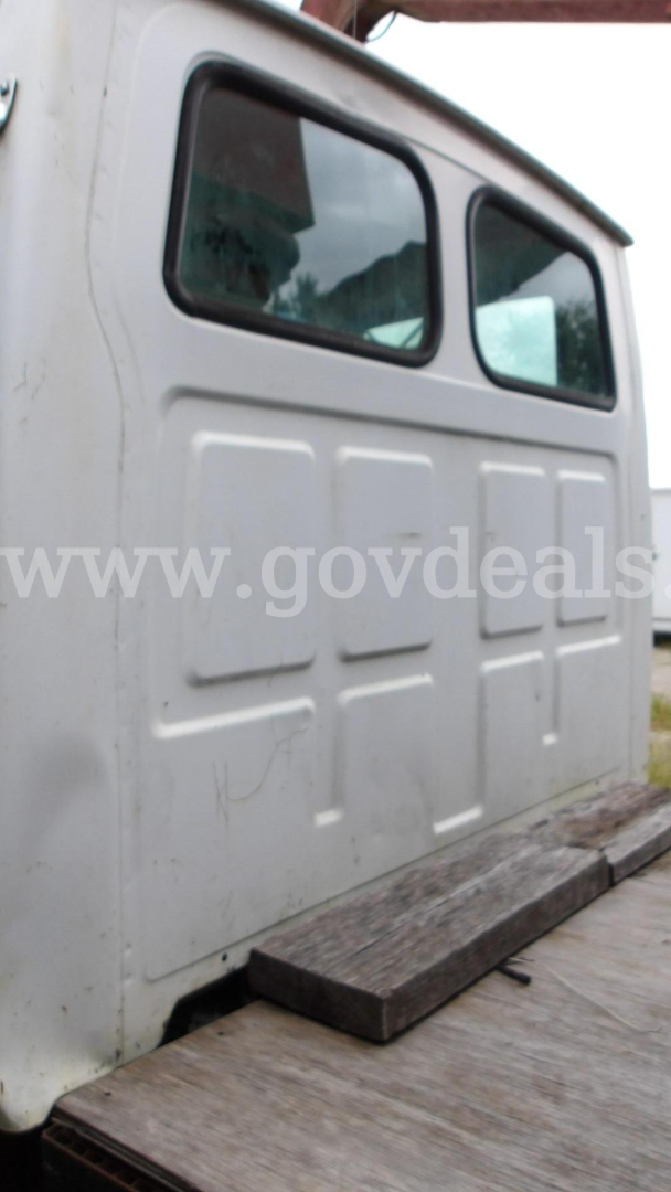 Truck cab rear side showing windowed cabin and door panel with embossed rectangular shapes.