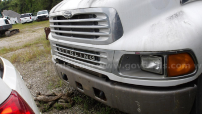 Front view of a Sterling Acterra truck showing the grille with Sterling badge and bumper; headlight and side marker visible.