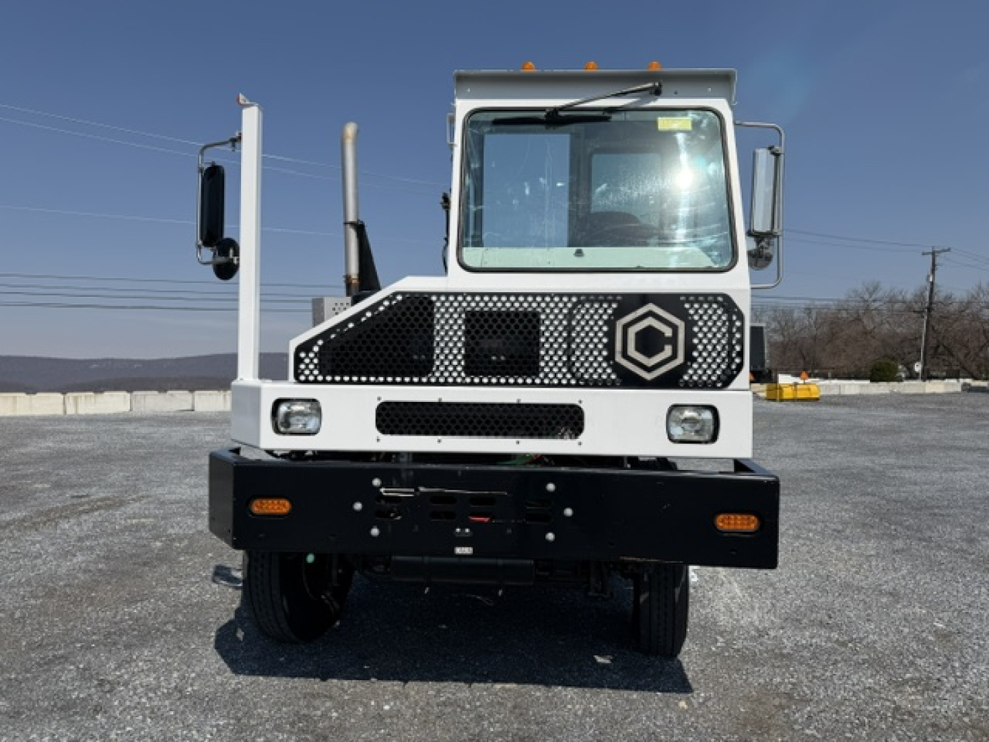 Front view of a white Capacity Sabre yard truck showing grille, headlights, and cab with Capacity logo