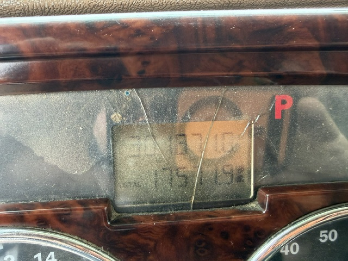Mack CV713 instrument cluster with small display, woodgrain dashboard trim visible