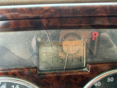 Mack CV713 instrument cluster with small display, woodgrain dashboard trim visible
