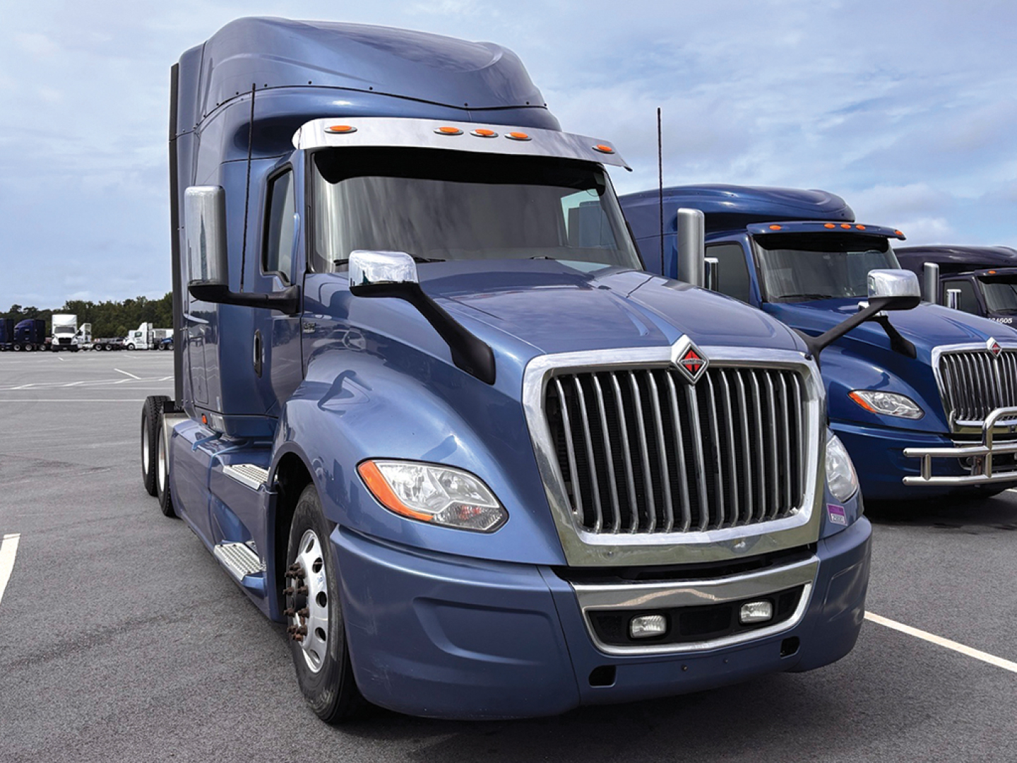 Truck cab front view of a blue 2020 International LT625 sleeper with chrome grille and large headlights.