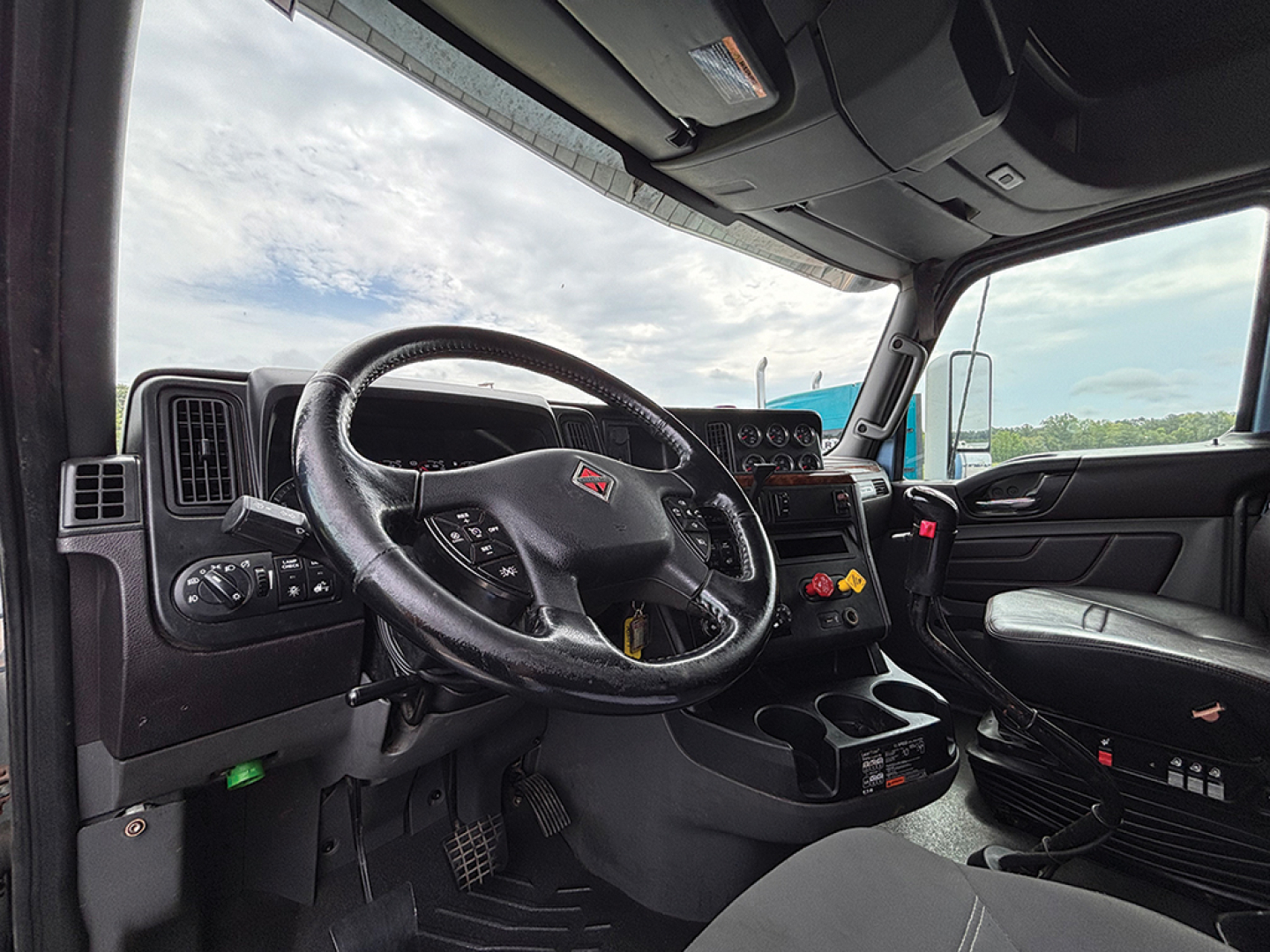 Interior of a 2020 International LT625 truck cabin with steering wheel, dashboard, and driver seat visible.