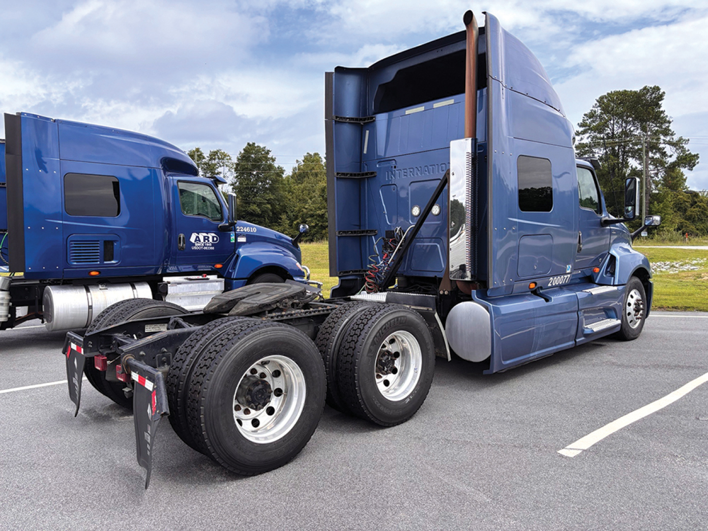 Truck: 2020 International LT625 with sleeper cab, side view, dual rear axles, blue exterior; visible text includes INTERNATIONAL on sleeper cab and rear badge.