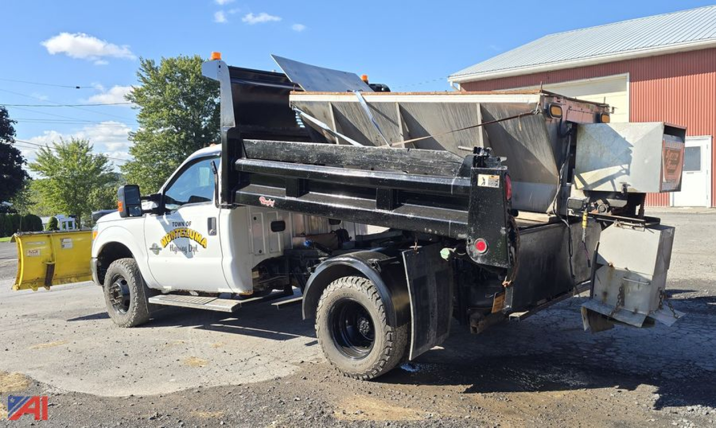 Ford F-350 dump truck with plow and wing attachment in serviceable condition showing hydraulic dump bed and auxiliary equipment