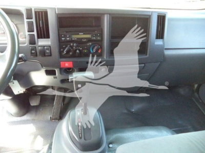 Isuzu NPRR cab interior showing dashboard controls and gear shift.