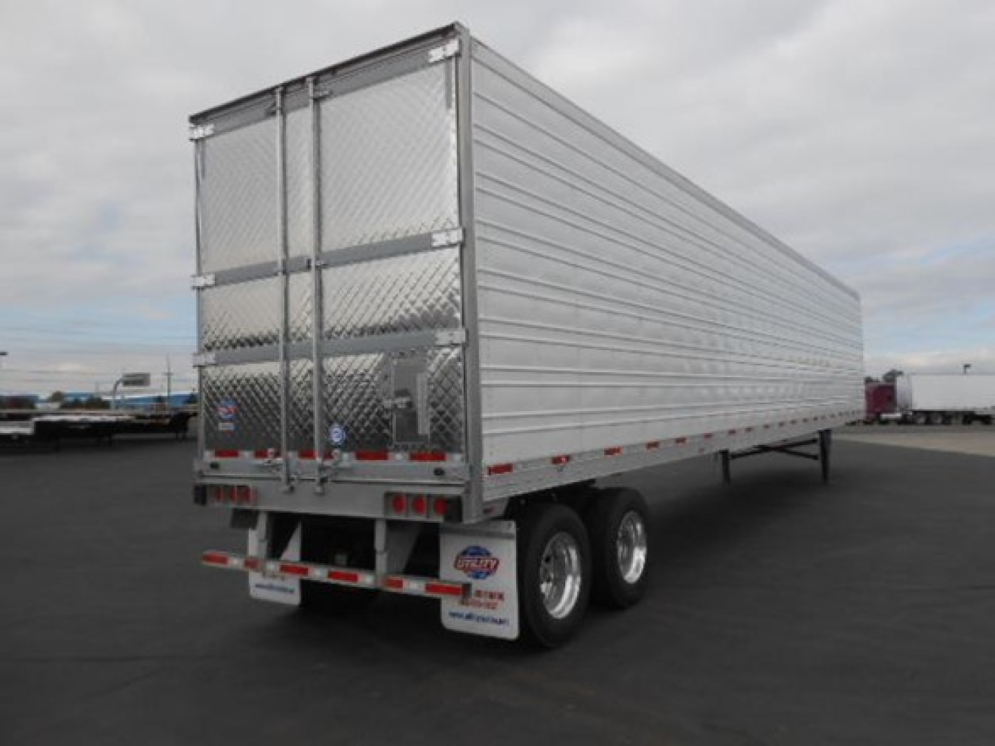 Utility 3000R trailer rear and side view showing aluminum panels and dual rear doors.