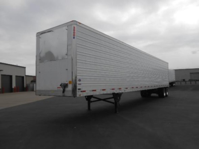 Utility 3000R trailer shown in side/rear view. Exterior metal ribbed walls, front and rear doors visible, landing gear extended, no visible branding other than small label near rear edge.