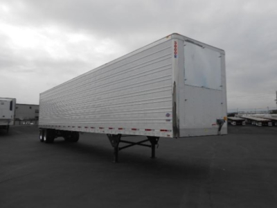 Utility 3000R trailer side and rear view showing corrugated aluminum walls, standard roll-up rear doors, and landing gear. Side text not legible.