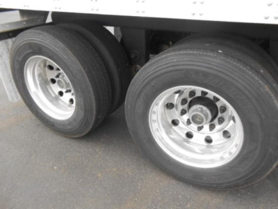 Dual rear trailer wheels and tires under a Utility 3000R trailer.