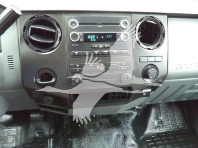 Dashboard view of a 2017 Ford F650 SD interior showing center console with radio, climate controls, circular air vents, and storage compartment.