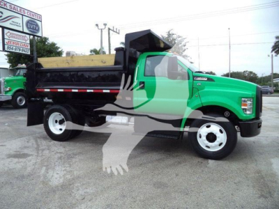 Dump truck in green and black, side view showing dump bed and wheels.