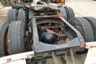 Frame and rear axle of a Volvo VNR64T300 truck chassis showing dual rear wheels, drivetrain, and fifth wheel area with visible maintenance markings.