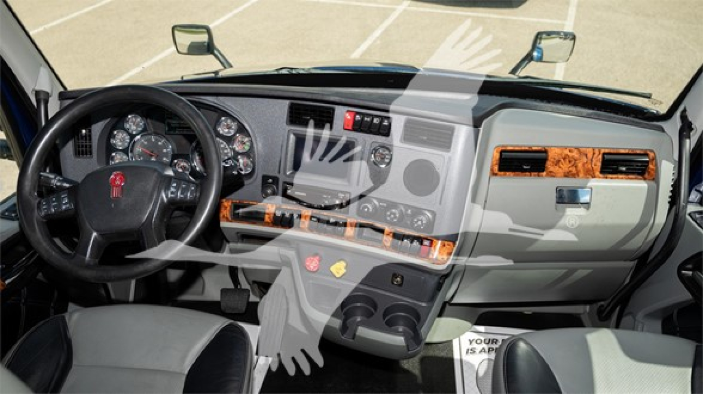 Kenworth T680 truck interior cockpit view showing steering wheel dashboard and center console.