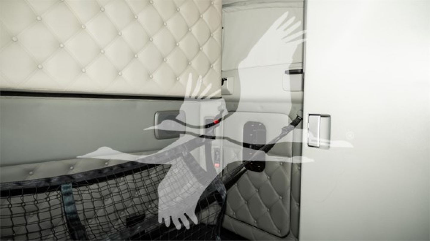 Kenworth T680 sleeper cab interior showing quilted upholstery and door area.