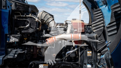 Kenworth T680 engine bay with visible turbocharger and intercooler piping, diesel engine components, and hoses.