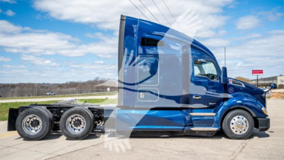 Kenworth T680 semi-truck in blue, side view, with sleeper cab and tandem rear axles.