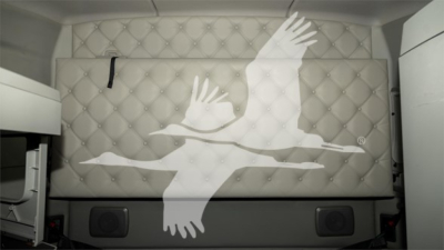 Kenworth T680 sleeper cab side with large white geese-like graphic on quilted panel; no visible text other than the graphic.