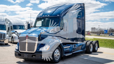 Truck side view showing a blue 2020 Kenworth T680 Sleeper in a dealership lot