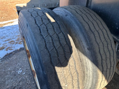 Trailer tires visible with wear on tread in front of wheel fender.