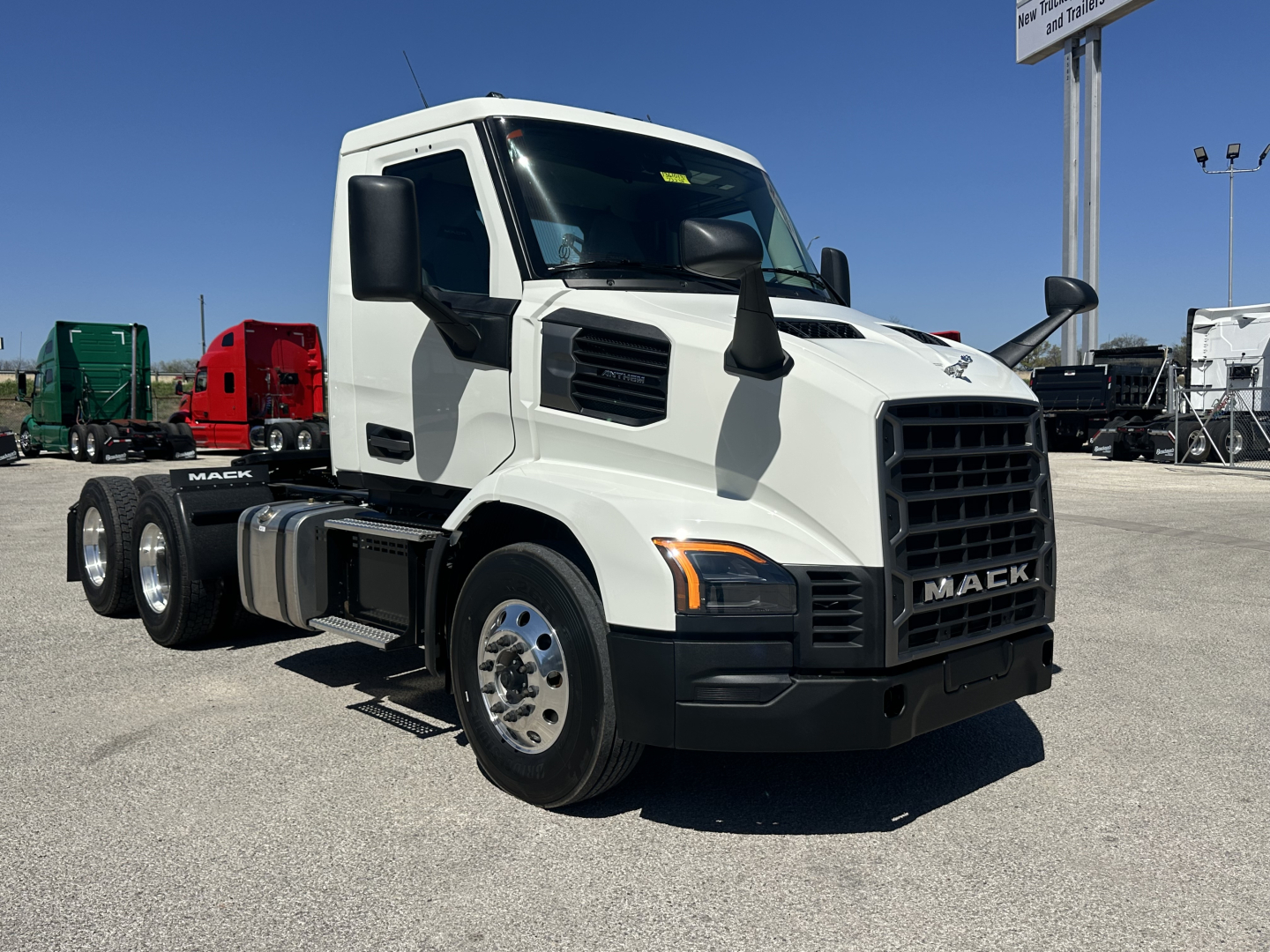 Front-left view of a white 2027 Mack AN64T conventional daycab truck with black grille and large mirrors.