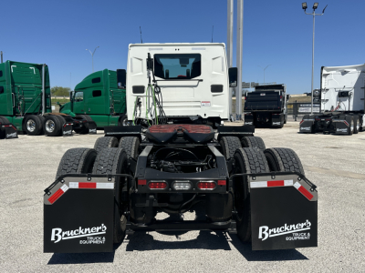 Truck chassis back view showing dual rear axles and mudflaps with Bruckner's Truck & Equipment logos.